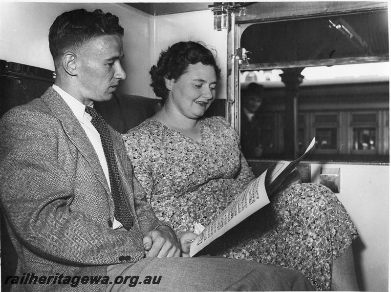 P00305
AH class carriage, internal view of a compartment showing seated passengers.
