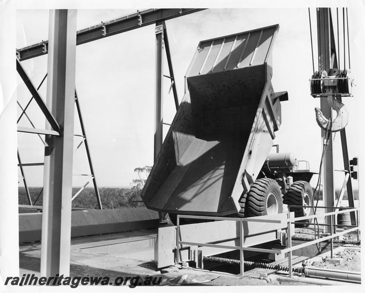 P00374
Dump truck with tray raised on loading platform, Koolyanobbing iron ore mine.
