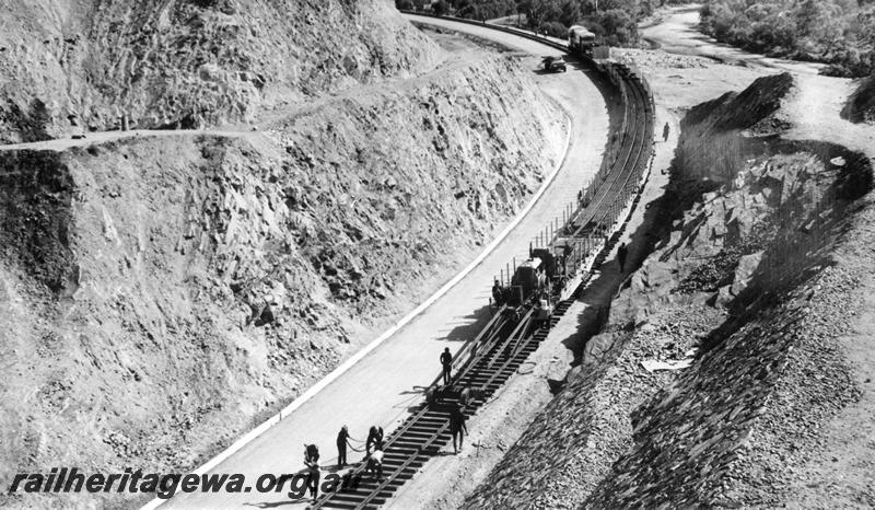 P00376
Standard gauge construction, tracklaying in Windmill Cutting, rail train being unloaded, elevated view
