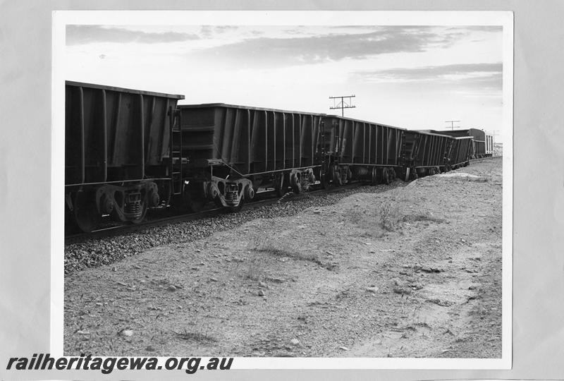 P00394
WO class standard gauge iron ore wagons, derailed near Kellerberrin, view along the line of wagons, date of the derailment 19/2/1974
