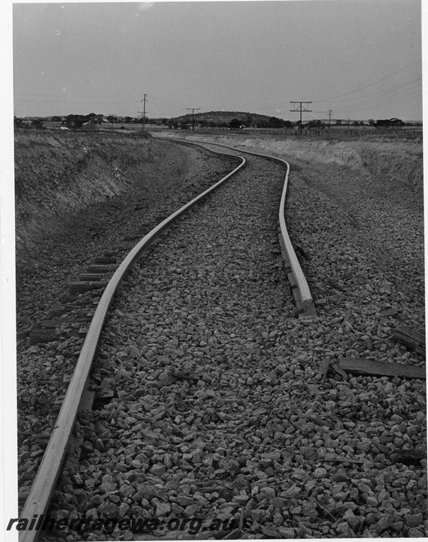 P00397
Track, distorted due to derailment of an iron ore train near Kellerberrin, view along the track,  date of the derailment 19/2/1974
