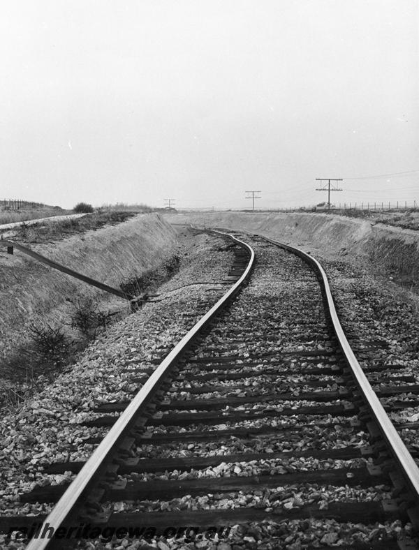 P00398
Track, distorted due to derailment of an iron ore train near Kellerberrin, view along the track
