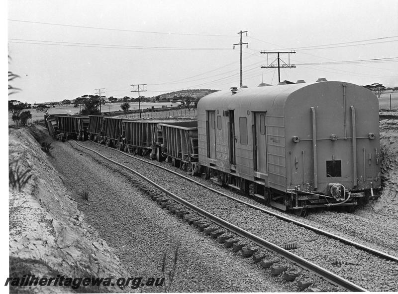 P00399
WBA class standard gauge brakevan, WO class wagons, derailed near Kellerberrin, view down the line of wagons,  date of the derailment 19/2/1974
