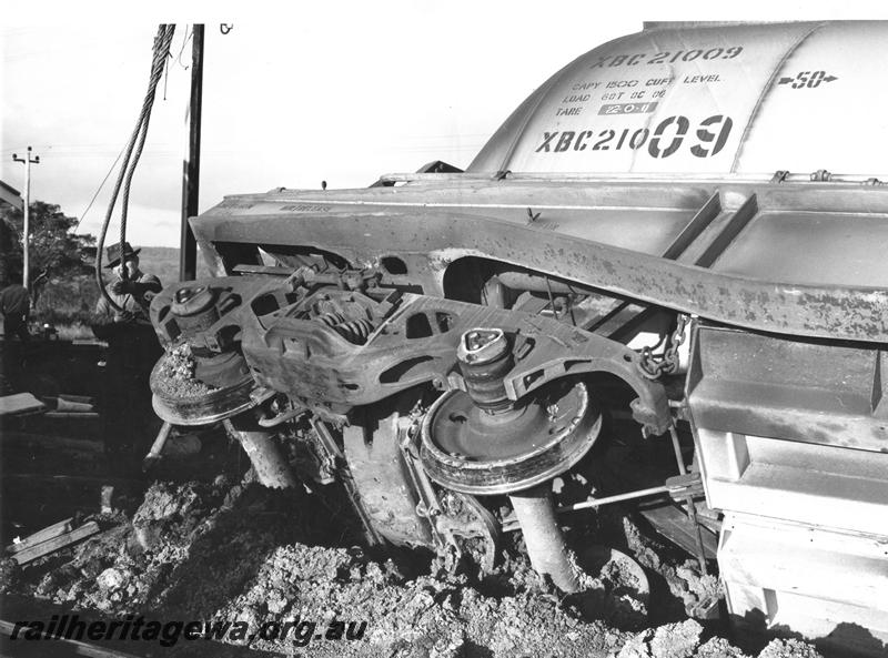 P00449
3 of 4 views of the derailment of a bauxite train at Mundijong, XBC class 21009 bauxite hopper derailed, view of the end of the wagon and the bogie.
