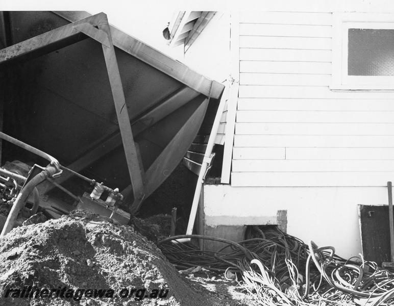 P00450
4 of 4 views of the derailment of a bauxite train at Mundijong, view shows derailed XBC class bauxite hopper resting against a relay cabin, end view.
