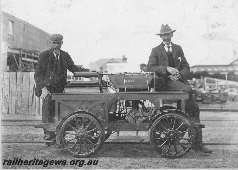 P00526
Ganger's trolley, early version, motorised, two operators on the trolley, side view.
