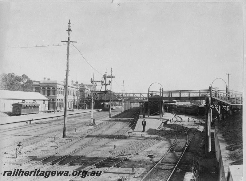 P00535
Station buildings, platforms, footbridge, signal, yard, Perth Station, view from the east end looking west, N class 200 at right hand platform, side loading carriage with sun shades over the windows in the dock platform
