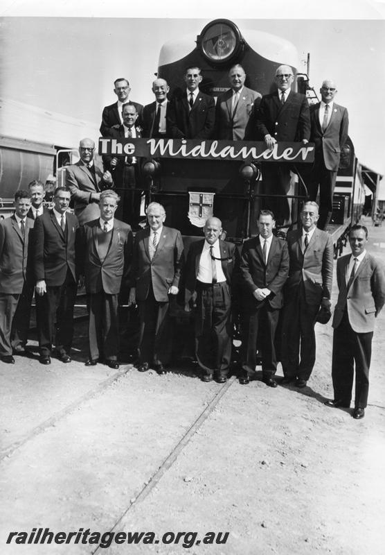 P00536
Group photo of WAGR officials in front of a F class loco, Geraldton for the Sunshine Festival, Commissioner of Railways, Mr. C. G. C. Wayne second from the right on the loco footplate.
