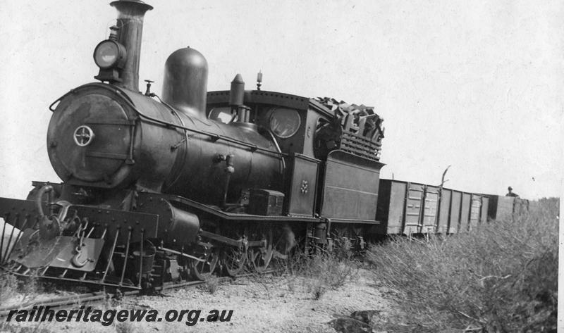 P00547
G class 58 with wood fuel hauling a pair of WAGR wagons, front and side view.
