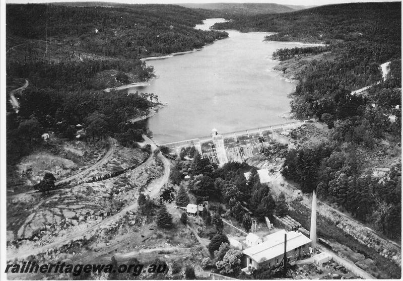 P00590
Mundaring Weir, aerial view taken from a RAAF aircraft. Shows the zig zag leading down to the pumping station
