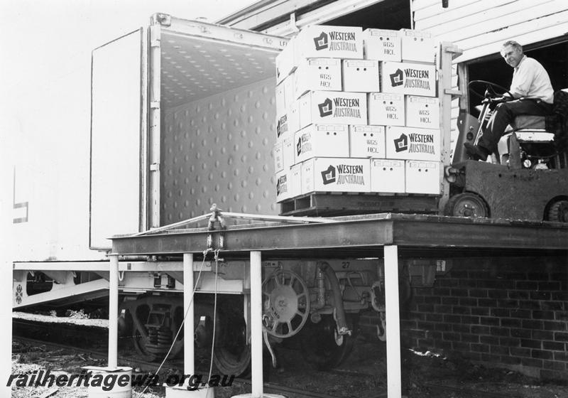 P00794
Apples being loaded into a container on a flat wagon, Bridgetown, PP line
