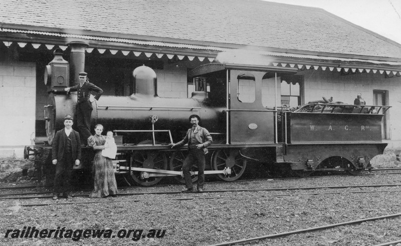 P01013
M class 2-6-0 at the original Northampton railway station, side view, staff and lady with a baby posing in front of the loco.
