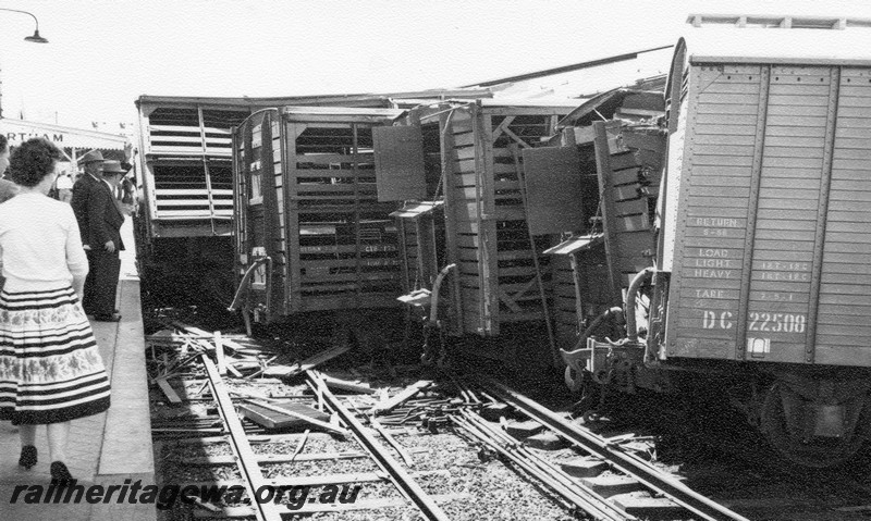 P01025
3 of 10 views of the derailment of A class 1501 at Northam Station, ER line. DC class 22508 and other wagons at right angles to the track next to the station platform, date of derailment 2/11/1961
