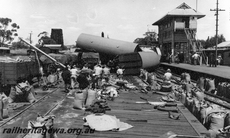 P01026
4 of 10 views of the derailment of A class 1501 at Northam Station, ER line. Wagons derailed and laying at right angles to the platform, signal box, debris scattered all around. date of derailment 2/11/1961
