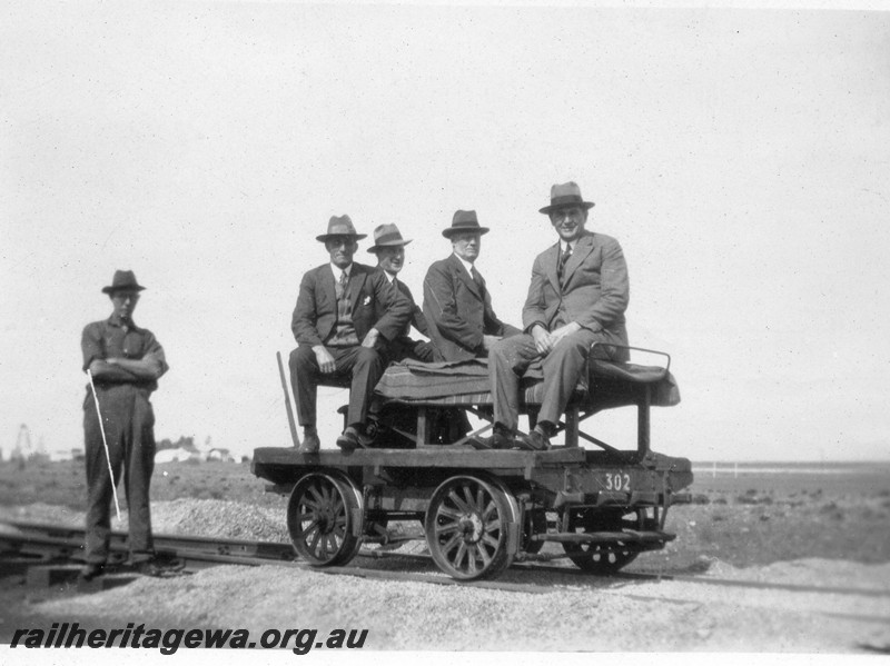 P01064
Railway Officers seated on a motorised ganger's trolley No.302, handing over inspection of the Meekatharra to Wiluna line, NR line
