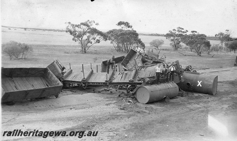 P01074
2 of 3 views of the derailment of No. 11 Mixed at the 51 mile point near Indarra, NR line, on the  2nd March 1932, showing derailed wagons piled up across the track. Q class 3234 in the view. Photo taken from the chimney of the cottage at 51 mile.
