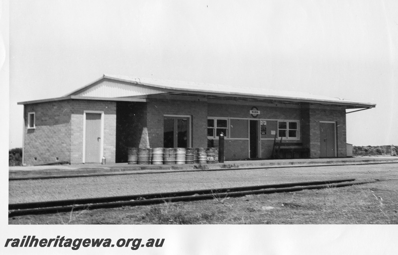 P01509
Station buildings, Wubin, EM line, end and trackside view, brick version, beer kegs on the platform.
