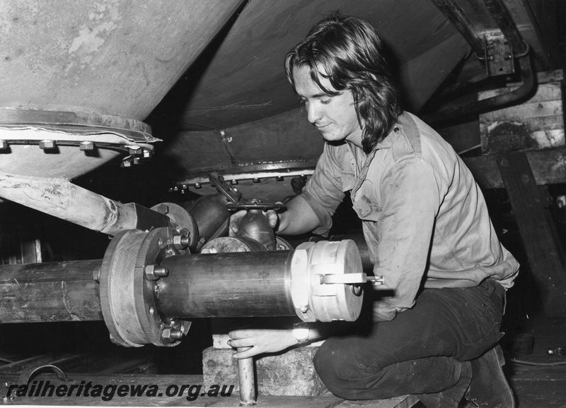 P01521
WAGR employee R. Outred, Midland Workshops, at work under a wagon
