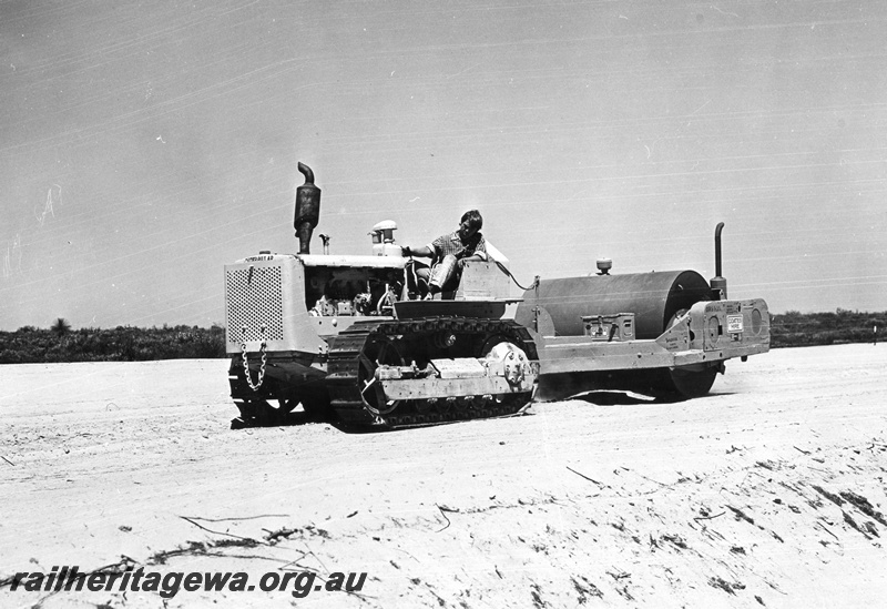 P01597
Caterpillar tractor hauling a roller, earthworks on the Dongara to Eneabba railway DE line
