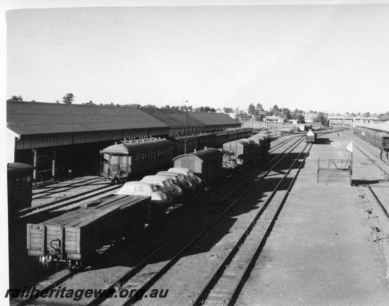 P01704
Kalgoorlie station yard, looking east, lever frame, passenger carriages, goods wagons, sheds.
