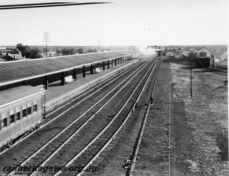 P01705
Kalgoorlie station yard, looking west, passenger platforms, sheds, water column, signal posts.
