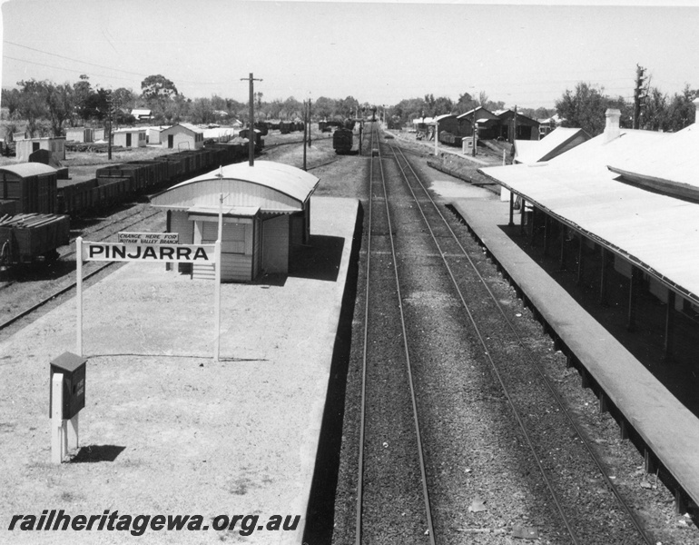 P01711
Station buildings Pinjarra, looking south from the footbridge, nameboard, loco and carriage sheds, water column, passenger platform, 