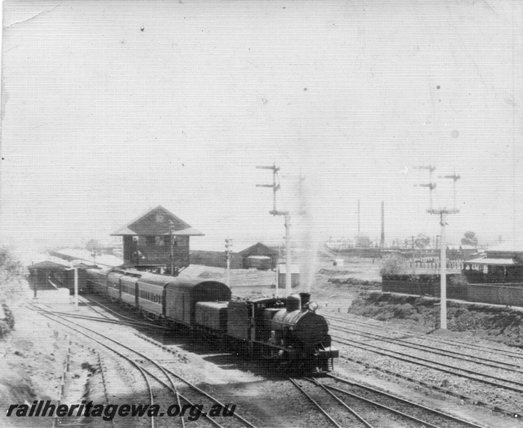 P01761
Commonwealth Railways (CR) G class steam loco. signals, signal box, Kalgoorlie, TAR Line, view from the Maritana Street Bridge looking west, Trans train departing
