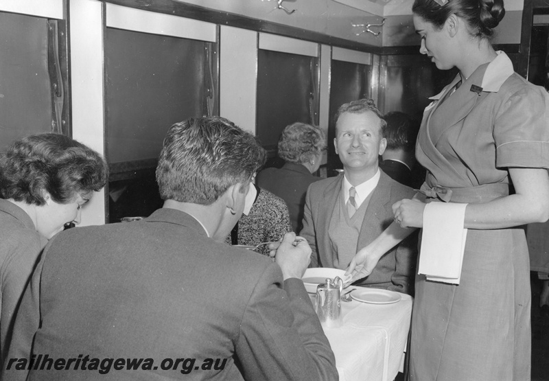 P01771
AV class Dining carriage, interior view showing a waitress serving passengers their meal
