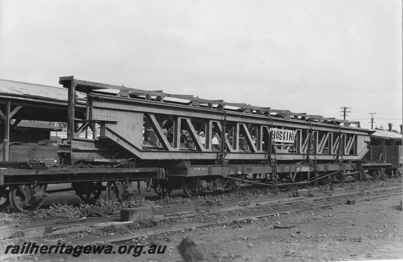 P01774
3 of 3 views of QA class 9393 bogie flat wagon carrying an over length electric crane traverser for the Great Boulder Mine, loaded at Perth Goods Yard, end and side view.
