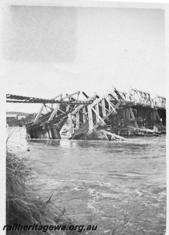 P01803
Collapsed bridge, North Fremantle, due to the 1926 flood, shows rails suspended and the collapsed trusses.
