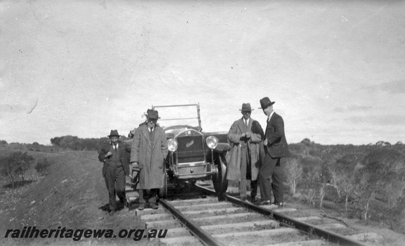 P01966
Inspection car rail mounted with inspection party standing around the car, GA line, front on view
