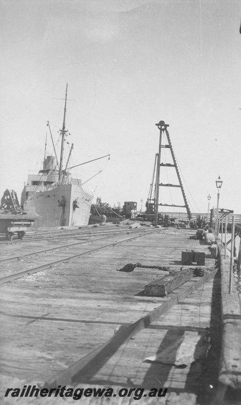 P01990
Jetty, Port Hedland, H class 22 in the background, ship berthed at the jetty, view along the jetty
