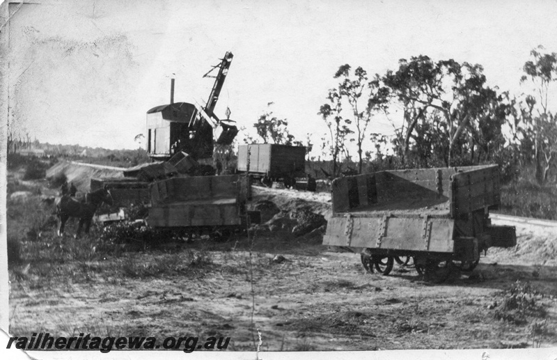 P02014
12 of 14. Ruston steam shovel, on embankment, 4 wheeled side tipping wagons, one wagon with side down showing interior of wagon, several wagons derailed, draught horse, side and front view, construction of Denmark-Nornalup railway, D line.
