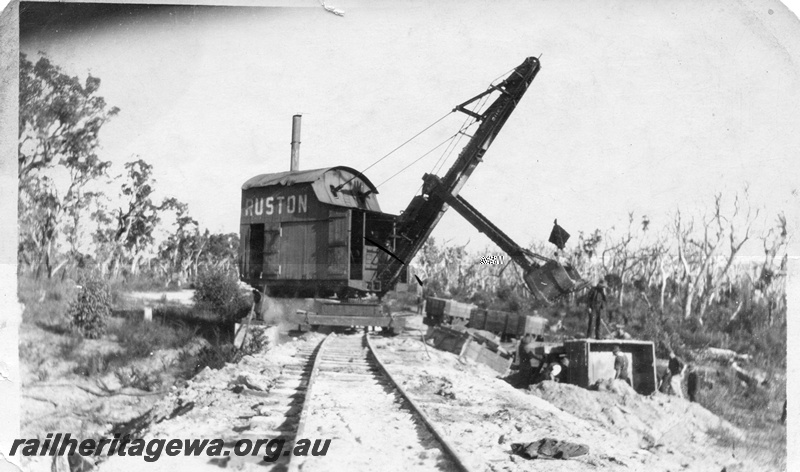 P02015
13 of 14. Ruston steam shovel on embankment clearing derailed side tipping wagons, side and front view, construction of Denmark-Nornalup railway, D line.
