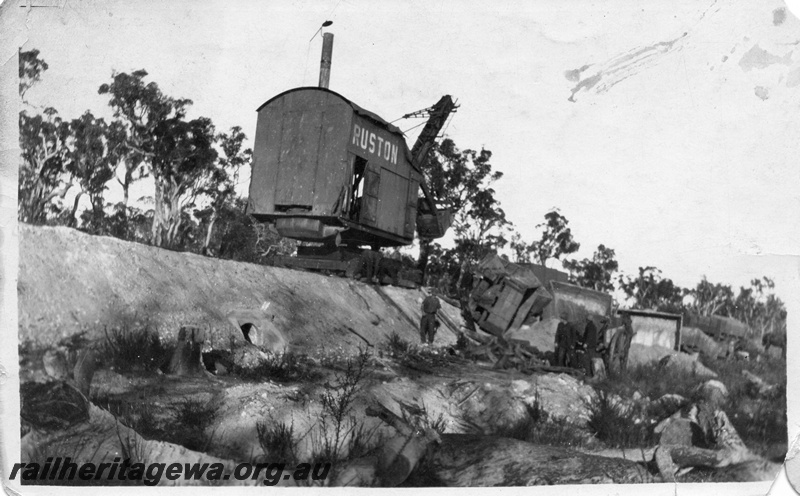 P02016
14 of 14. Ruston steam shovel on embankment clearing derailed side tipping wagons, side and front view, head walls on culvert of embankment, construction of Denmark-Nornalup railway, D line.
