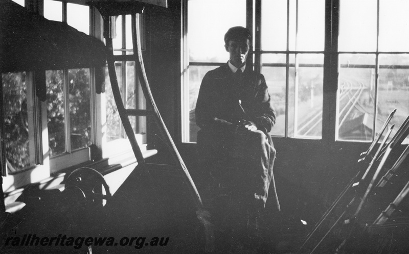 P02021
Signal box, Guildford, internal view showing the signalman and levers, c1926
