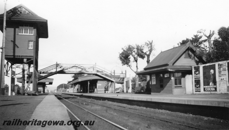 P02022
Station buildings, elevated and platform located signal boxes, footbridge, Guildford, overall view looking east along the track, c1926
