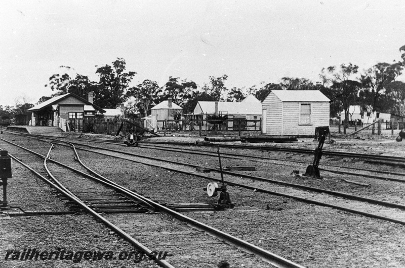 P02039
Station buildings, yard, point levers, Pingelly, GSR line, before take over by the WAGR, view along the yard, c1891
