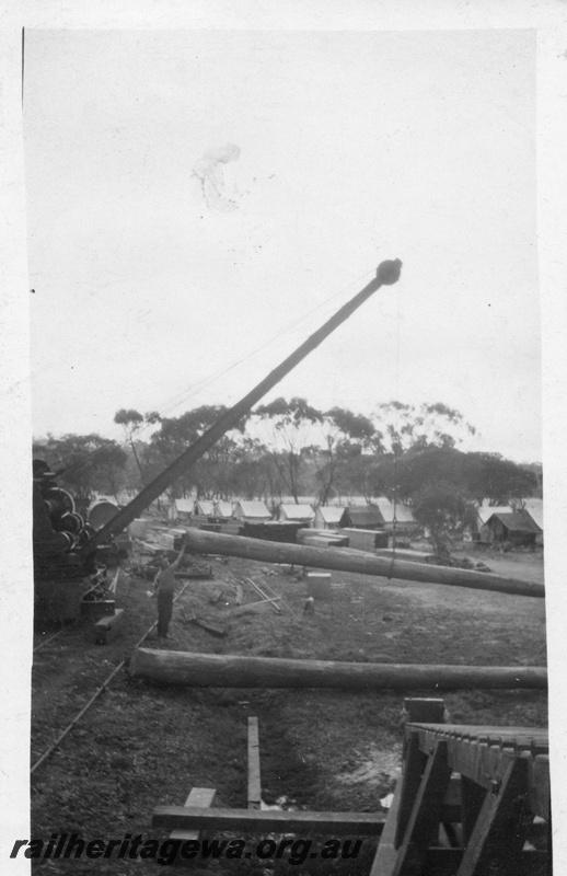 P02061
Steam crane, bridge construction, lifting a pile, workers camp in the background, possibly Guildford

