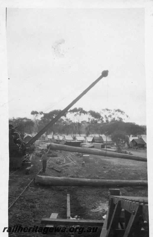 P02061
Steam crane, bridge construction, lifting a pile, workers camp in the background, possibly Guildford
