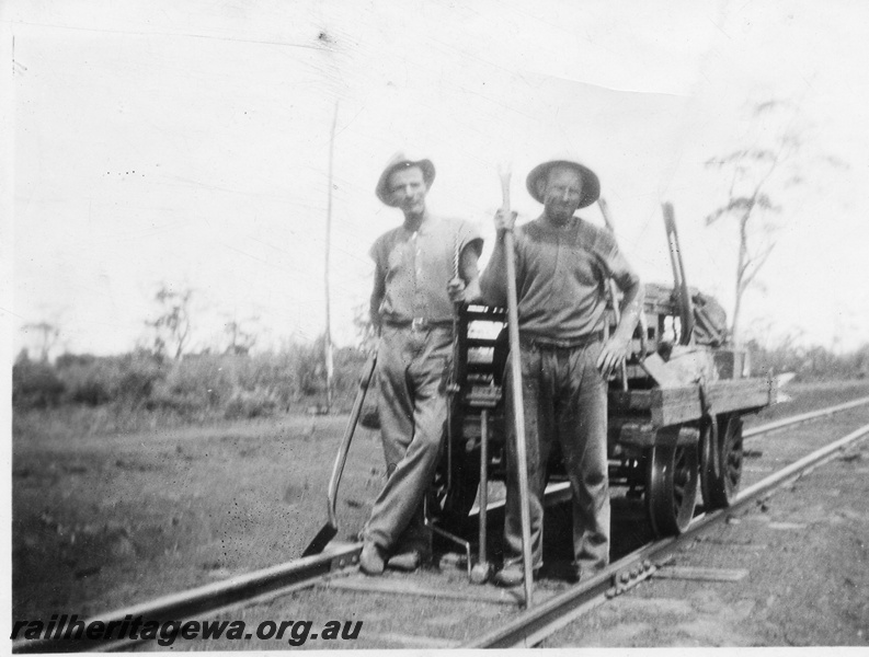 P02063
Fettlers with implements standing in front of a gangers trolley
