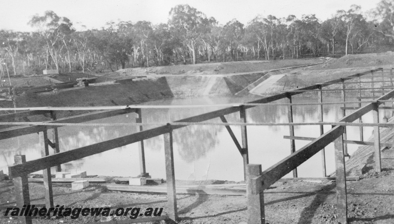P02065
1 of 12 views of the construction of a railway dam at Hillman, BN line, view of the dam from the south east corner showing first storage of water also showing first stages of roofing dam
