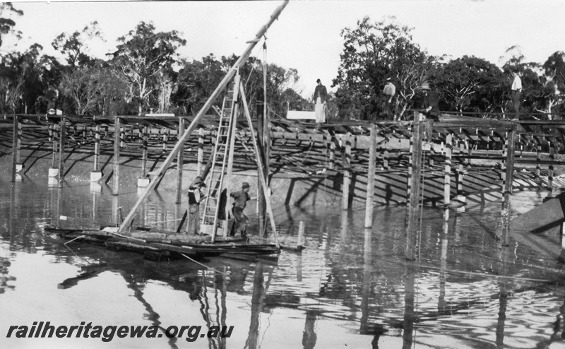 P02072
8 of 12 views of the construction of a railway dam at Hillman, BN line, view of raft showing post ready to be dropped into position
