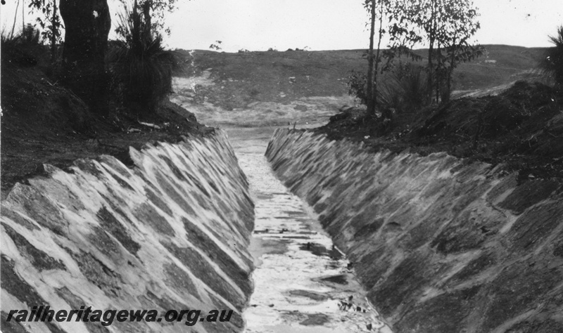 P02075
11 of 12 views of the construction of a railway dam at Hillman, BN line, looking up channel from Main Rock
