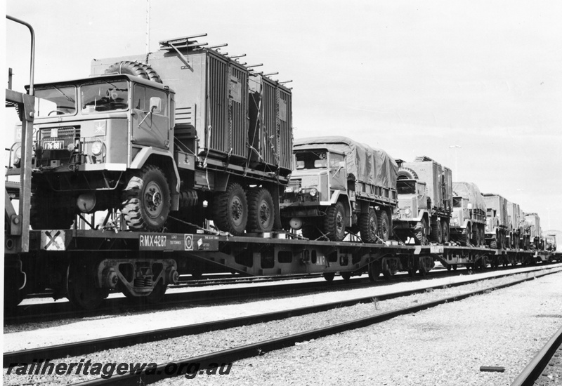 P02077
Army vehicles loaded onto ANR bogie flat wagons, view along the train
