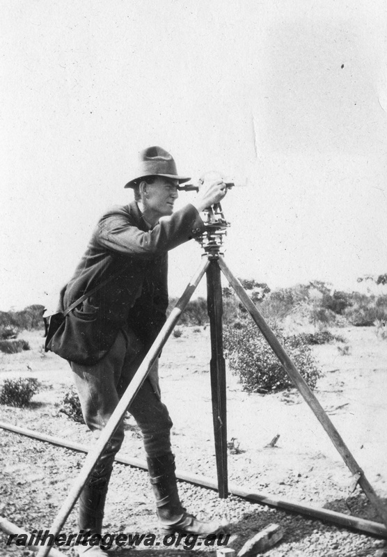 P02085
6 of 44 views of the construction of the railway at Esperance, CE line taken by Cedric Stewart, the resident WAGR engineer, surveyor using a theodolite, surveying the track
