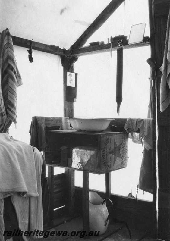 P02105
26 of 44 views of the construction of the railway at Esperance, CE line taken by Cedric Stewart, the resident WAGR engineer, worker's tent, internal view shows wash basin and jug.
