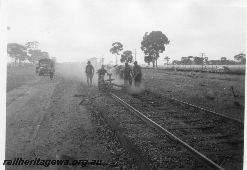 P02111
2 of 7 views of the early relaying of the track on the EGR, c1950, gangers operating a machine on the rails, view along the track
