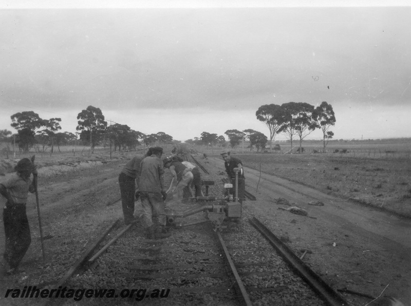 P02113
4 of 7 views of the early relaying of the track on the EGR, c1950, gangers operating a machine, view along the track
