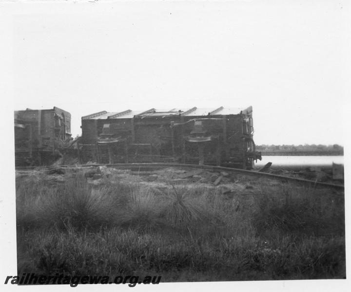 P02121
5 of 7 views of the derailment of No. 972 Goods near Westfield on the Jandakot to Armadale section of the FA line, a pair of GH class wagons derailed, one showing the underbody details,  date of derailment 10/8/1955
